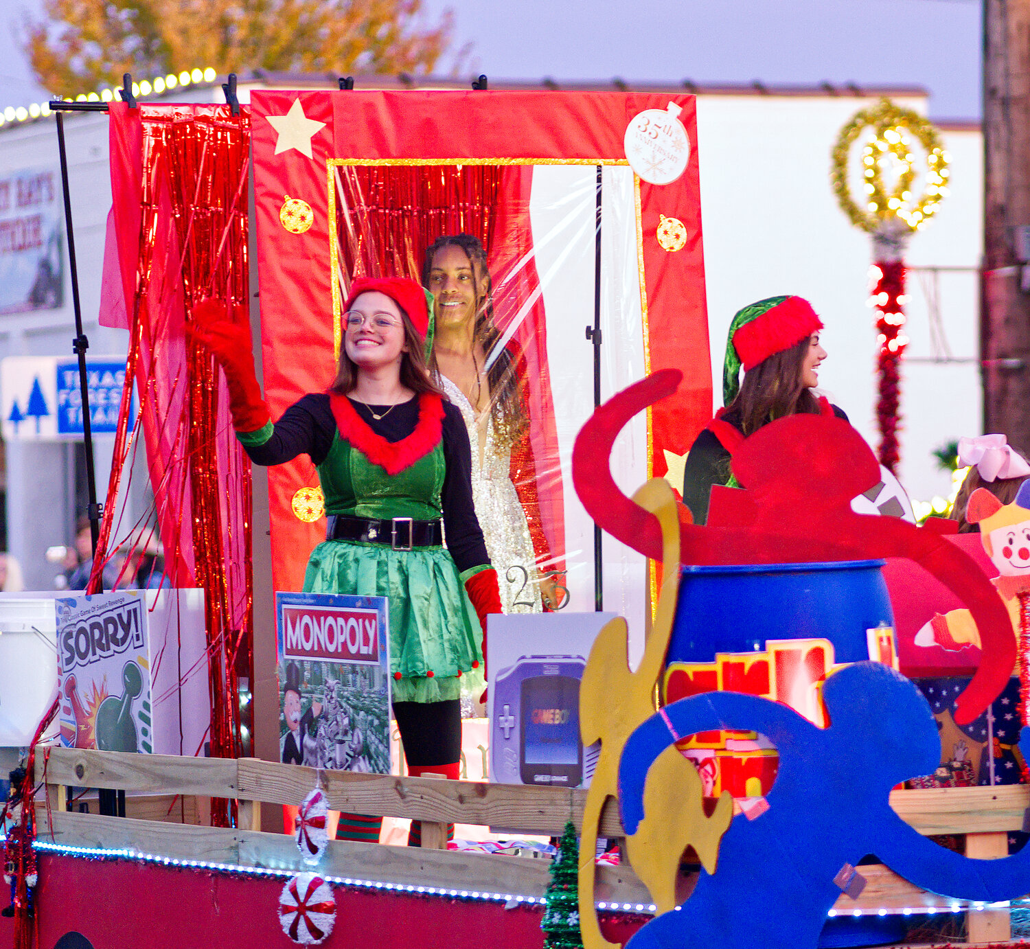 Left to right, Emilee Baker, Allie Berry and Sadie Vander Schaaf dressed as elves and barbie aboard the toyland float for LaDawn Foley-McGee. [further Quitman fun]